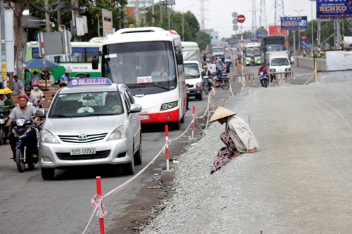 Người dân di chuyển mất an toàn trên đường Kinh Dương Vương, quận Bình Tân (đoạn trước Bến xe Miền Tây). Theo tìm hiểu, đường Kinh Dương Vương, đoạn từ vòng xoay Phú Lâm đến vòng xoay An Lạc sẽ được nâng lên để chống ngập. 