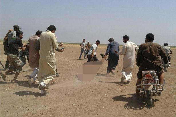 Civilians-appear-to-be-dragging-the-body-of-a-Russian-pilot-dragged-from-the-wreckage-of-a-Russian-helicopter-that-had