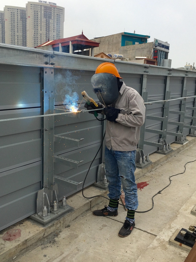 Trên công trường công nhân đang thi công hạng mục về điện, hàn thanh tiếp địa, để đảm bảo an toàn chạy tàu trong điều kiện mưa giống có sấm sét