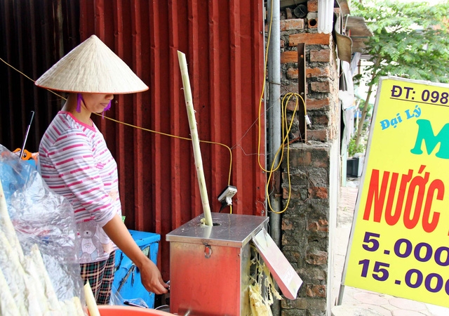 Chị Xuyên luôn phải làm luôn chân luôn tay để phục vụ nước mía cho khách hàng. Ảnh: k.O