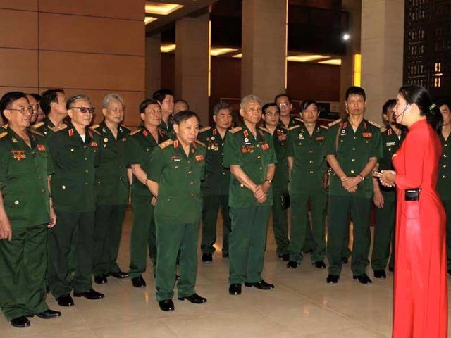 Hướng dẫn viên của Văn phòng Quốc hội hướng dẫn đoàn Ban liên lạc truyền thống cựu chiến binh Quân đoàn 2 tham quan Nhà Quốc hội. Ảnh: VPQH