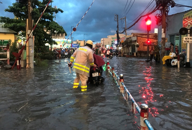 Lực lượng CSGT đã kịp thời có mặt để phân luồng, hướng dẫn người dân tìm hướng đi khác, đồng thời hỗ trợ các phương tiện ra khỏi vùng ngập nước.